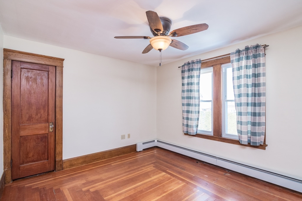 2 Oak Street Easthampton, MA 01027 - Photo 24 of 42 a view of an empty room with wooden floor and a window