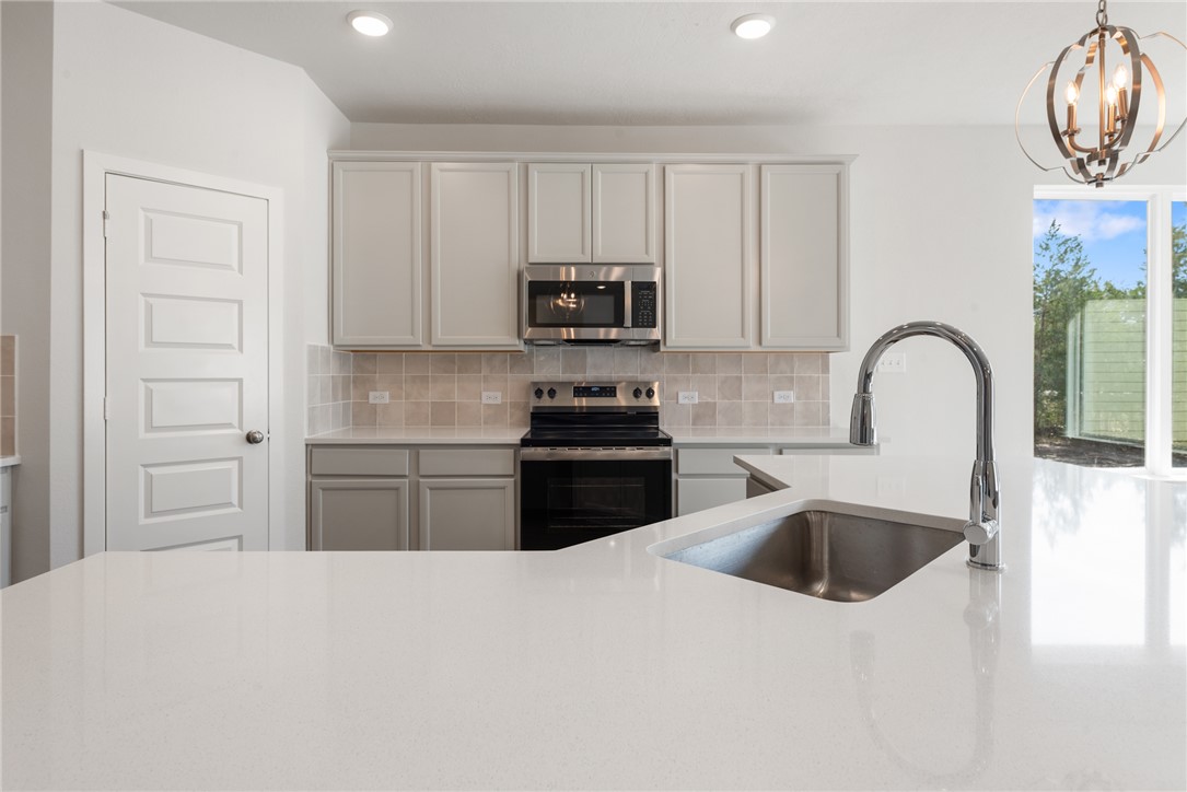 8452 Muir Wood Loop Anderson, TX 77830 - Photo 20 of 48 a kitchen with a sink and a refrigerator