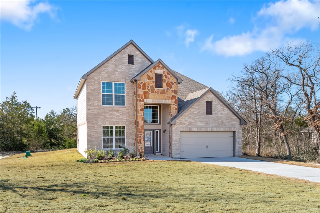 8452 Muir Wood Loop Anderson, TX 77830 - Photo 2 of 48 a front view of a house with a yard