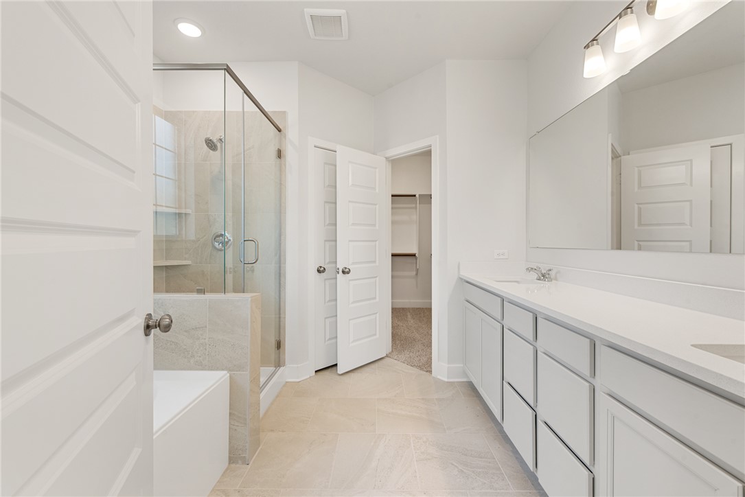 8452 Muir Wood Loop Anderson, TX 77830 - Photo 26 of 48 a bathroom with a bathtub and a shower
