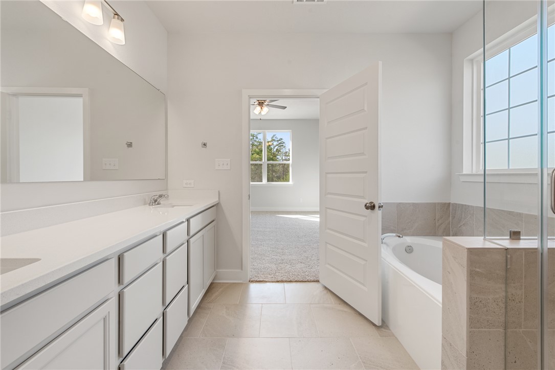 8452 Muir Wood Loop Anderson, TX 77830 - Photo 27 of 48 a bathroom with a bathtub and a sink