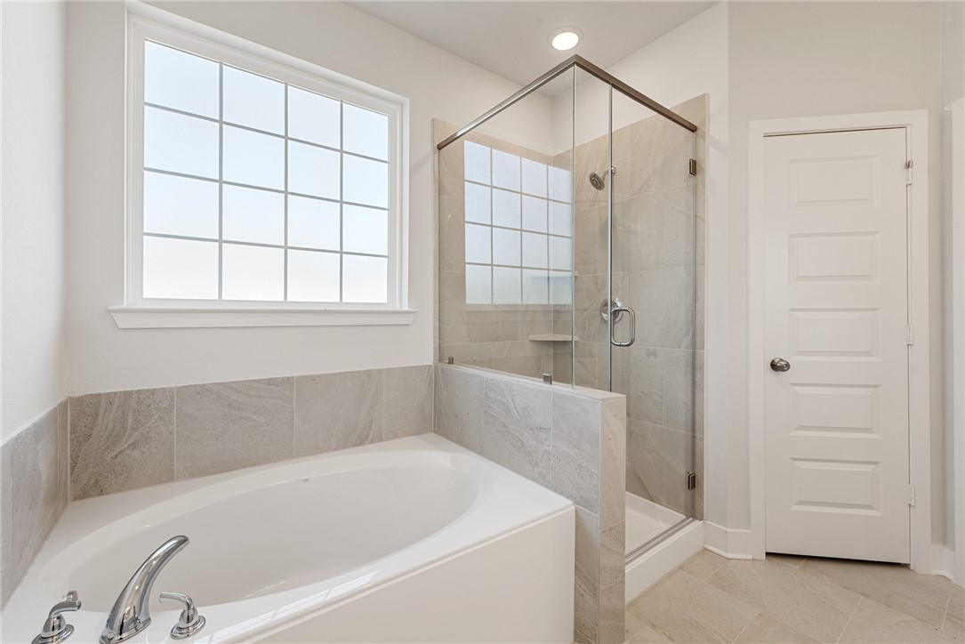 8452 Muir Wood Loop Anderson, TX 77830 - Photo 28 of 48 a bathroom with a bathtub and a shower