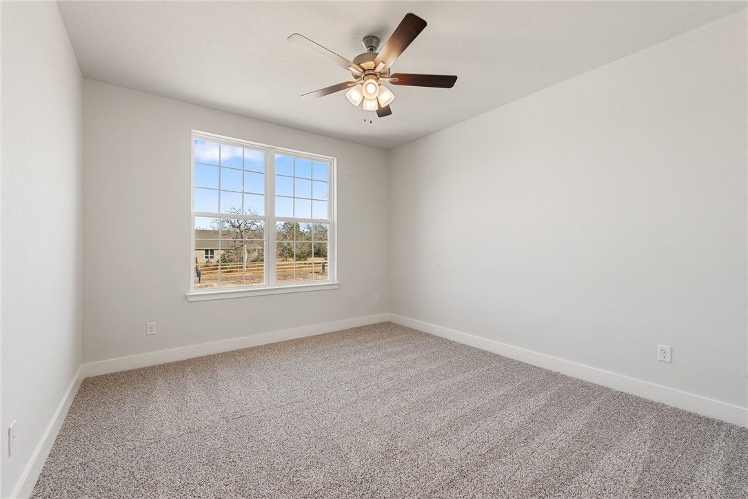 8452 Muir Wood Loop Anderson, TX 77830 - Photo 36 of 48 an empty room with a window and a fan