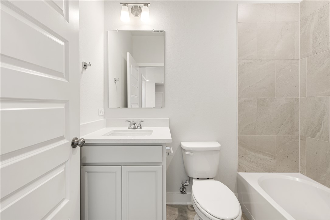 8452 Muir Wood Loop Anderson, TX 77830 - Photo 41 of 48 a bathroom with a toilet a sink and a bathtub