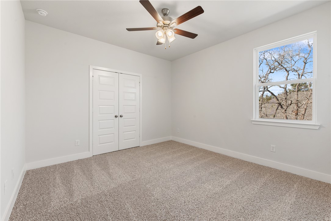 8452 Muir Wood Loop Anderson, TX 77830 - Photo 43 of 48 an empty room with windows and fan
