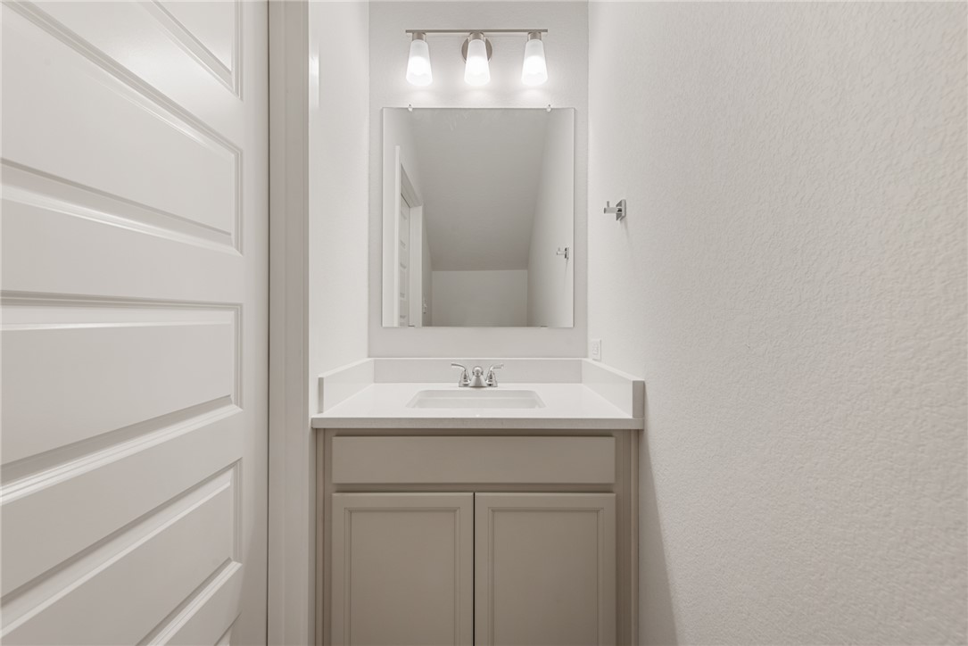 8452 Muir Wood Loop Anderson, TX 77830 - Photo 46 of 48 a bathroom with a sink and a mirror