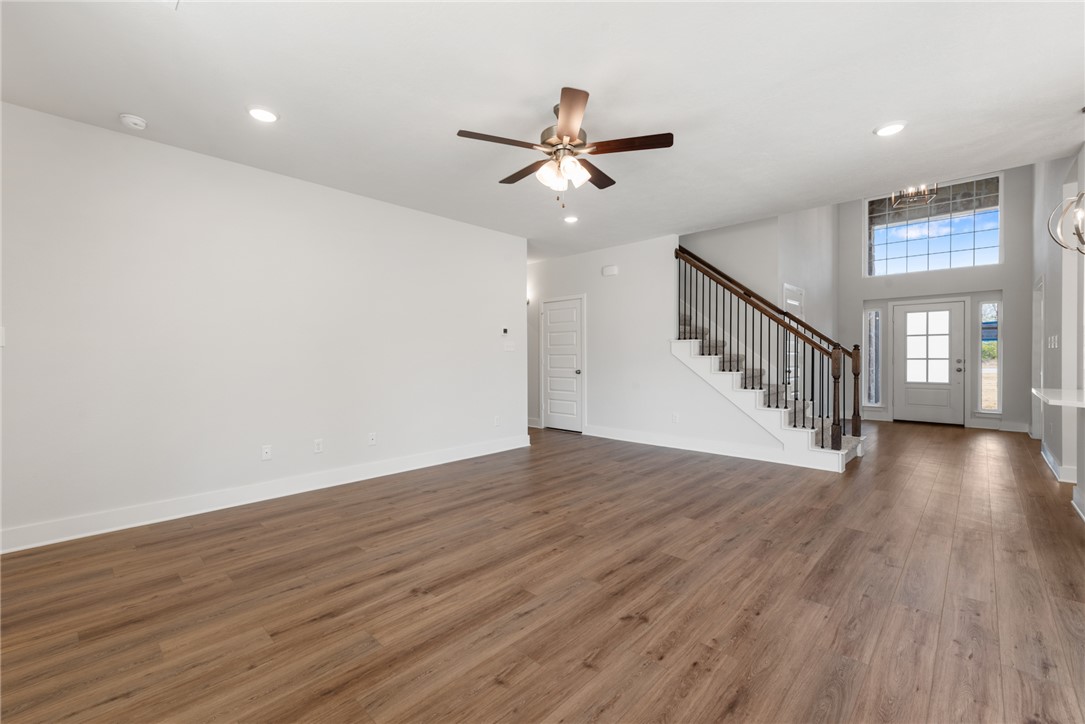 8452 Muir Wood Loop Anderson, TX 77830 - Photo 9 of 48 a view of an empty room with wooden floor and a window