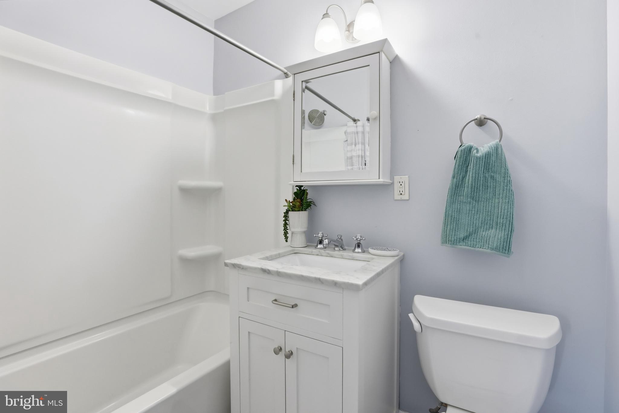 625 Chesapeake Street Southeast, Unit 301 Washington, DC 20032 - Photo 14 of 23 a bathroom with a toilet sink and mirror
