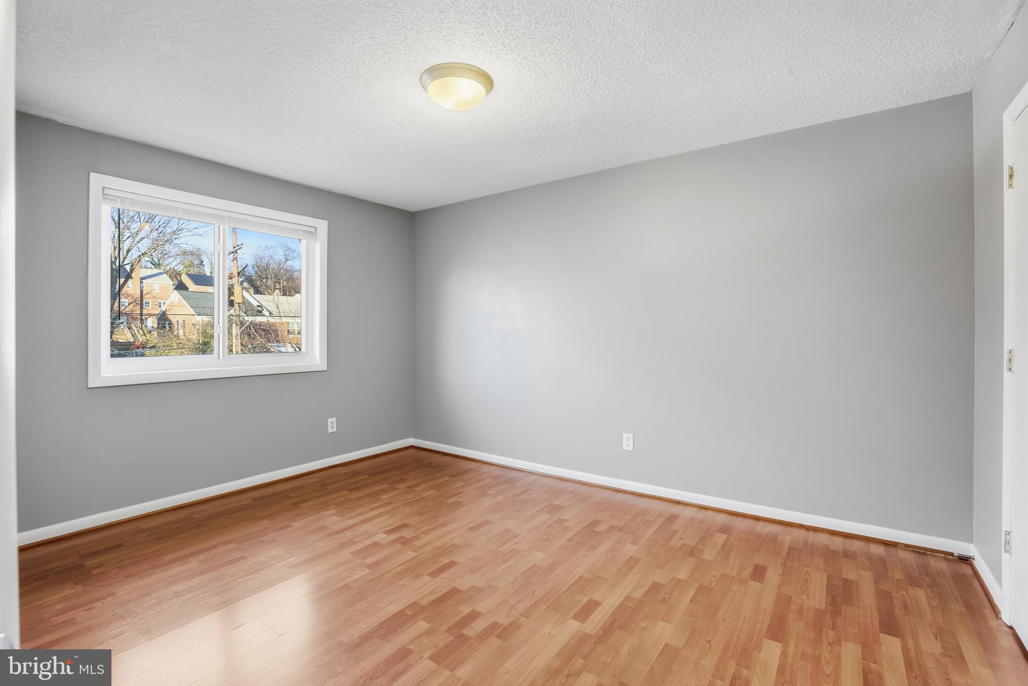 625 Chesapeake Street Southeast, Unit 301 Washington, DC 20032 - Photo 15 of 23 a view of room with window and wooden floor