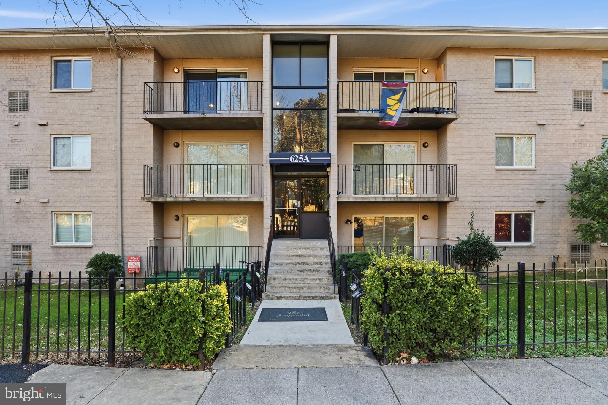 625 Chesapeake Street Southeast, Unit 301 Washington, DC 20032 - Photo 19 of 23 a front view of a house with a small yard