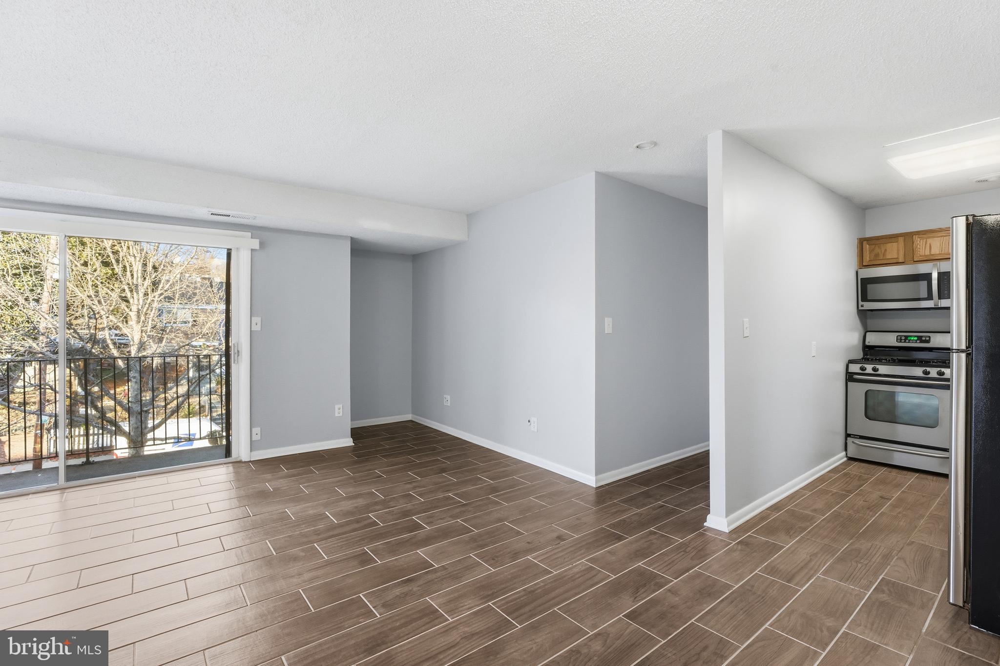 625 Chesapeake Street Southeast, Unit 301 Washington, DC 20032 - Photo 2 of 23 wooden floor in an empty room with a window