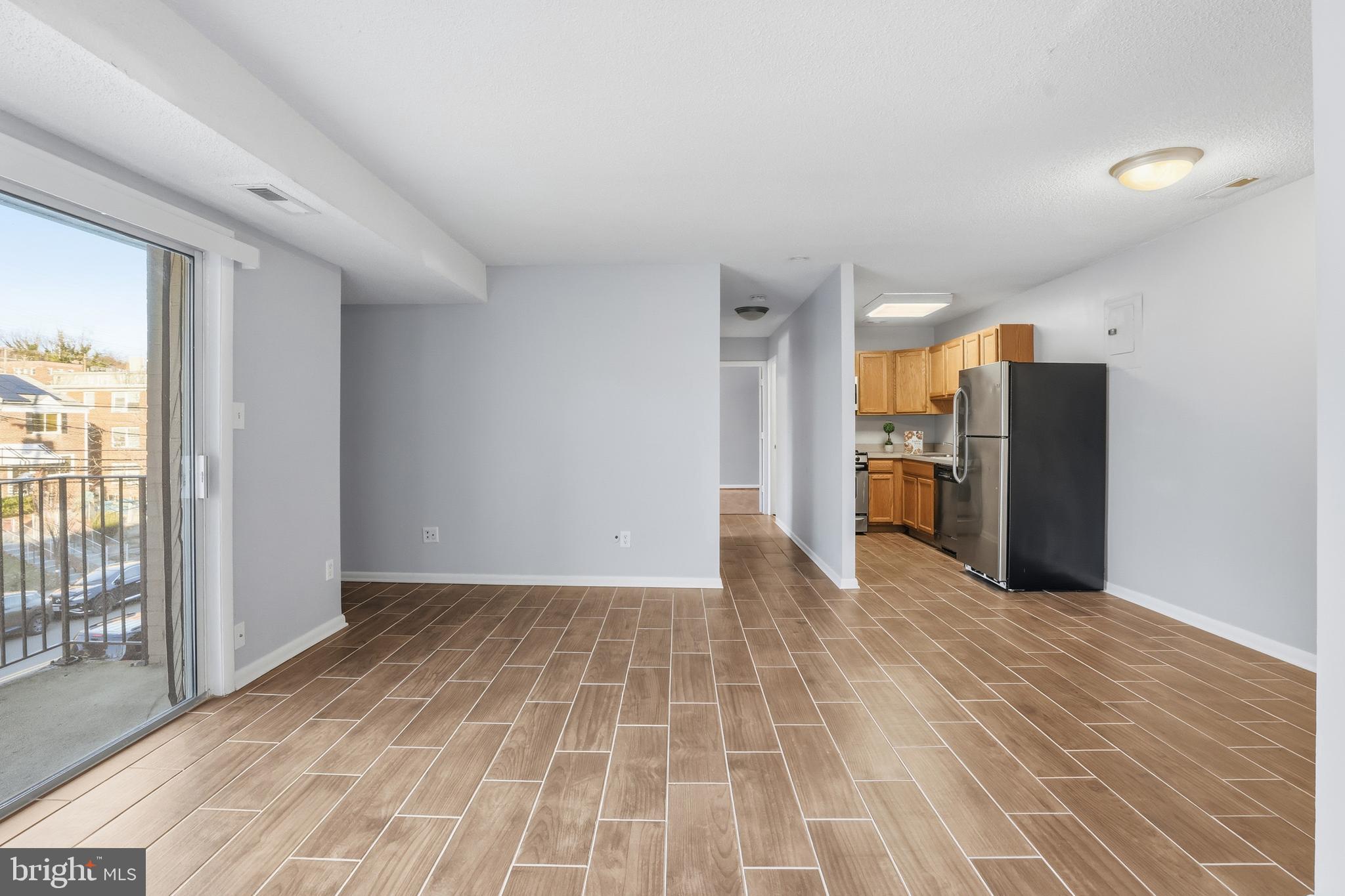 625 Chesapeake Street Southeast, Unit 301 Washington, DC 20032 - Photo 7 of 23 a view of a kitchen with a sink and a refrigerator