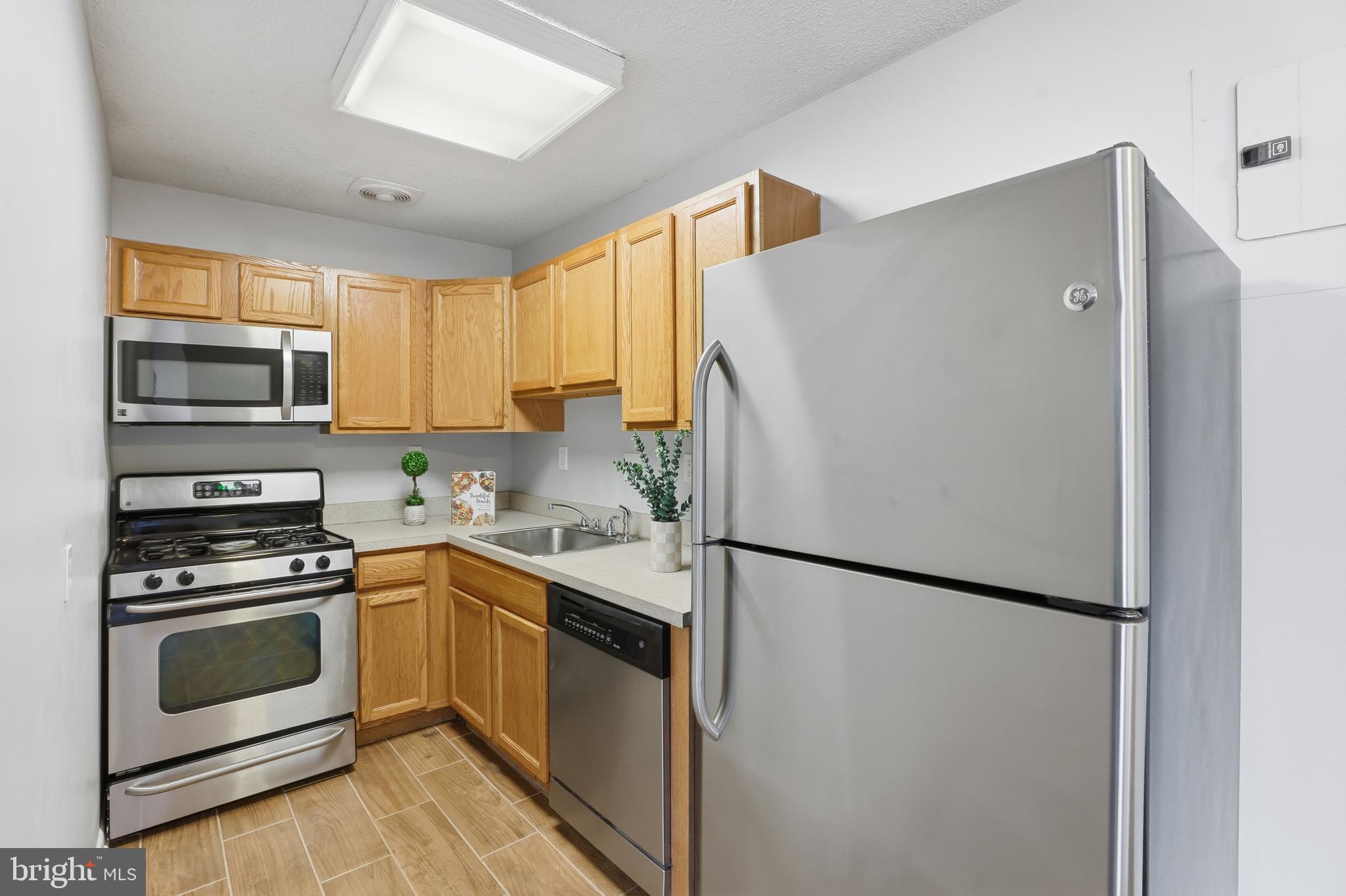 625 Chesapeake Street Southeast, Unit 301 Washington, DC 20032 - Photo 8 of 23 a kitchen with a refrigerator sink and stove