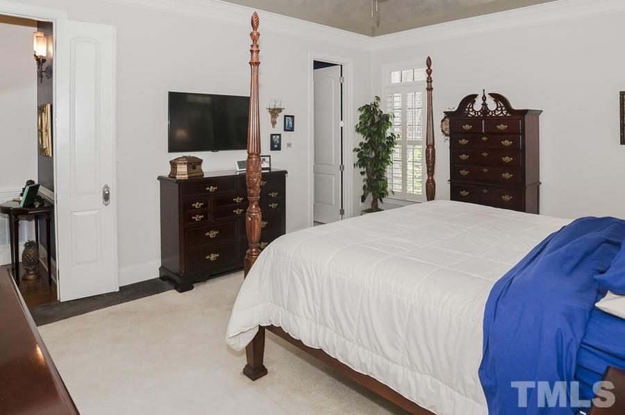 3317 Canoe Brook Parkway Raleigh, NC 27614 - Photo 16 of 67 a bedroom with a bed and a flat tv screen on dresser