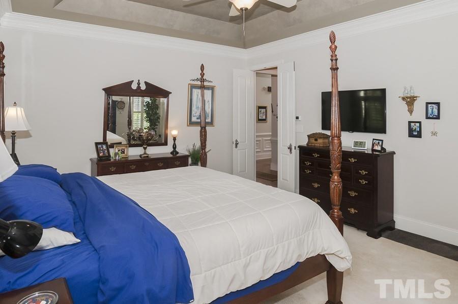 3317 Canoe Brook Parkway Raleigh, NC 27614 - Photo 17 of 67 a bedroom with a bed and a flat screen tv