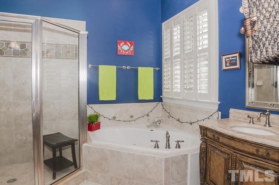 3317 Canoe Brook Parkway Raleigh, NC 27614 - Photo 19 of 67 a bathroom with a sink and a bathtub