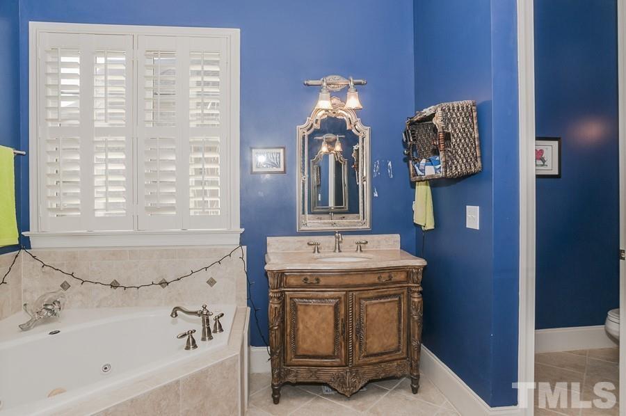 3317 Canoe Brook Parkway Raleigh, NC 27614 - Photo 20 of 67 a bathroom with a tub sink and mirror