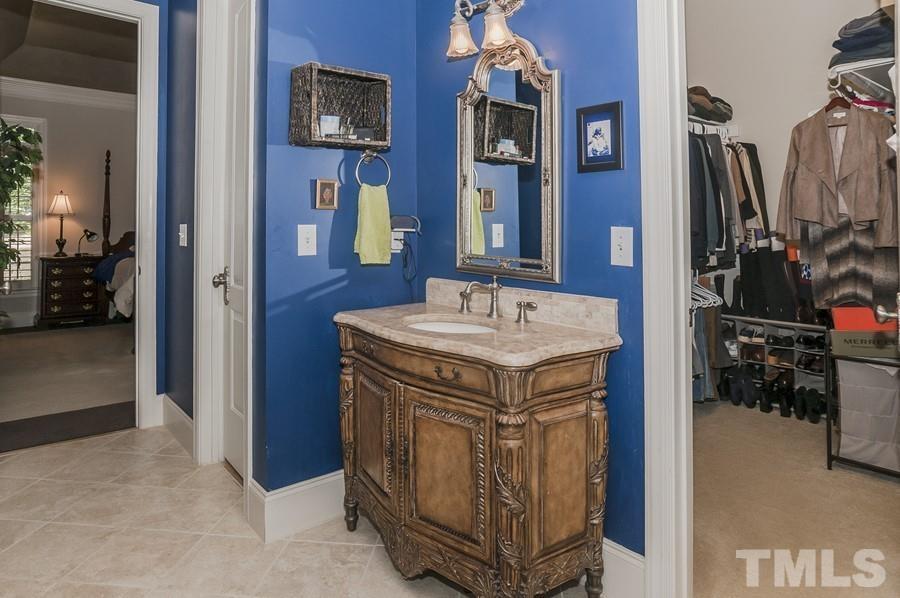3317 Canoe Brook Parkway Raleigh, NC 27614 - Photo 21 of 67 a bathroom with a sink a vanity and a mirror
