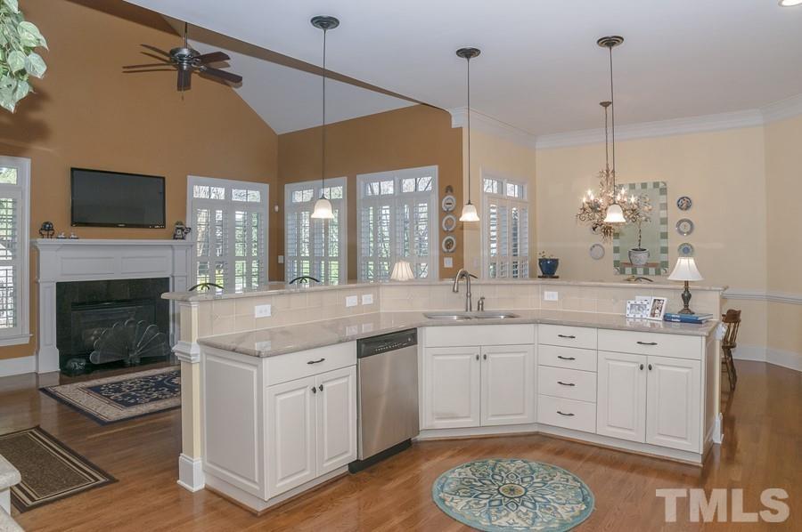 3317 Canoe Brook Parkway Raleigh, NC 27614 - Photo 23 of 67 a spacious kitchen with a sink a stove and a chandelier