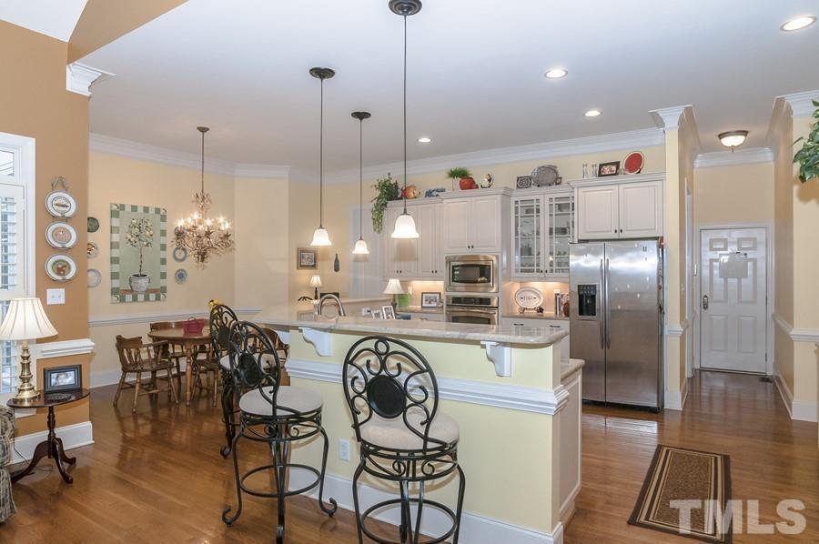 3317 Canoe Brook Parkway Raleigh, NC 27614 - Photo 24 of 67 a kitchen with refrigerator and chairs