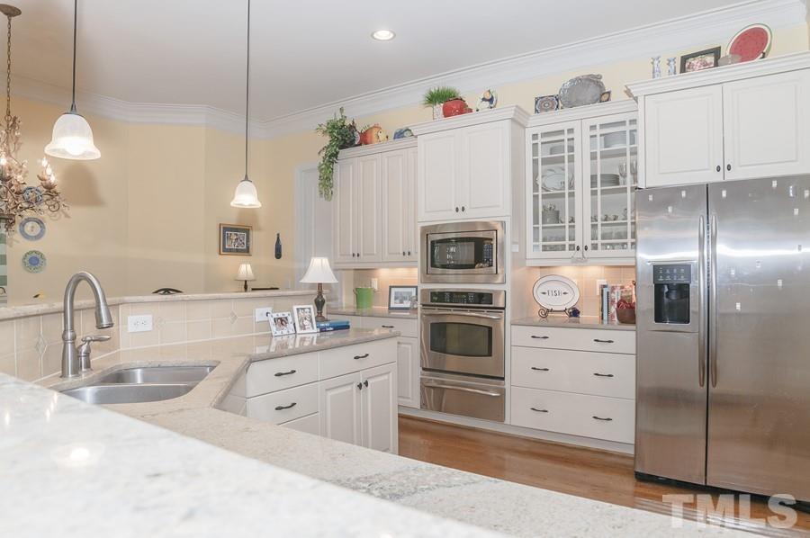 3317 Canoe Brook Parkway Raleigh, NC 27614 - Photo 29 of 67 a kitchen with granite countertop a sink and cabinets