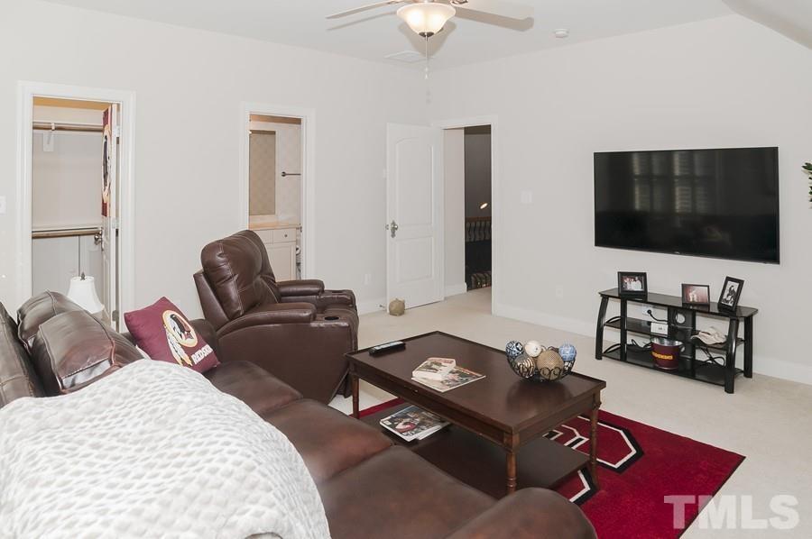 3317 Canoe Brook Parkway Raleigh, NC 27614 - Photo 35 of 67 a living room with furniture and a flat screen tv