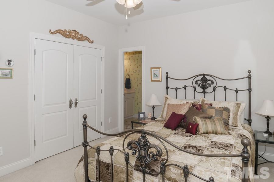 3317 Canoe Brook Parkway Raleigh, NC 27614 - Photo 40 of 67 a bed room with furniture and a chandelier