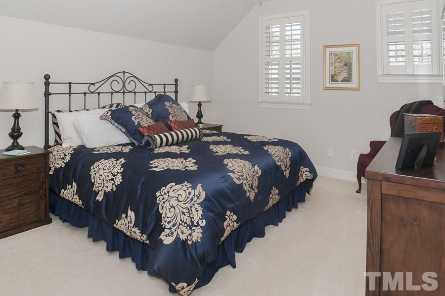 3317 Canoe Brook Parkway Raleigh, NC 27614 - Photo 43 of 67 a bed sitting in a bedroom next to a window with a lamp and a large window