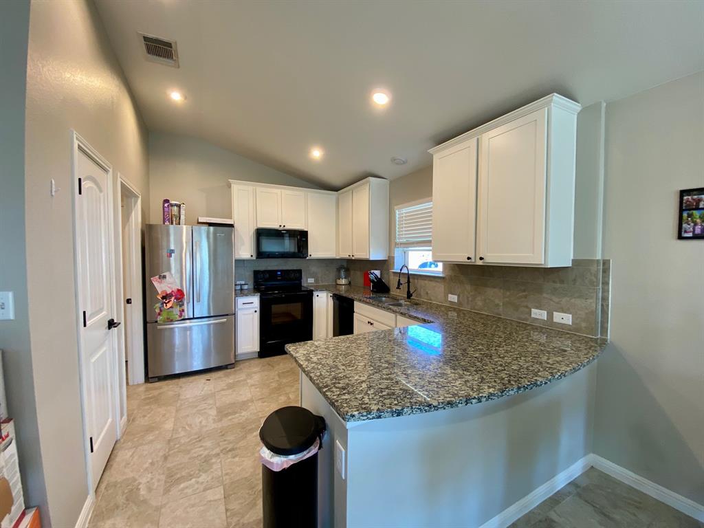 149 Red Sun Drive Kyle, TX 78640 - Photo 4 of 18 a kitchen with refrigerator and cabinets