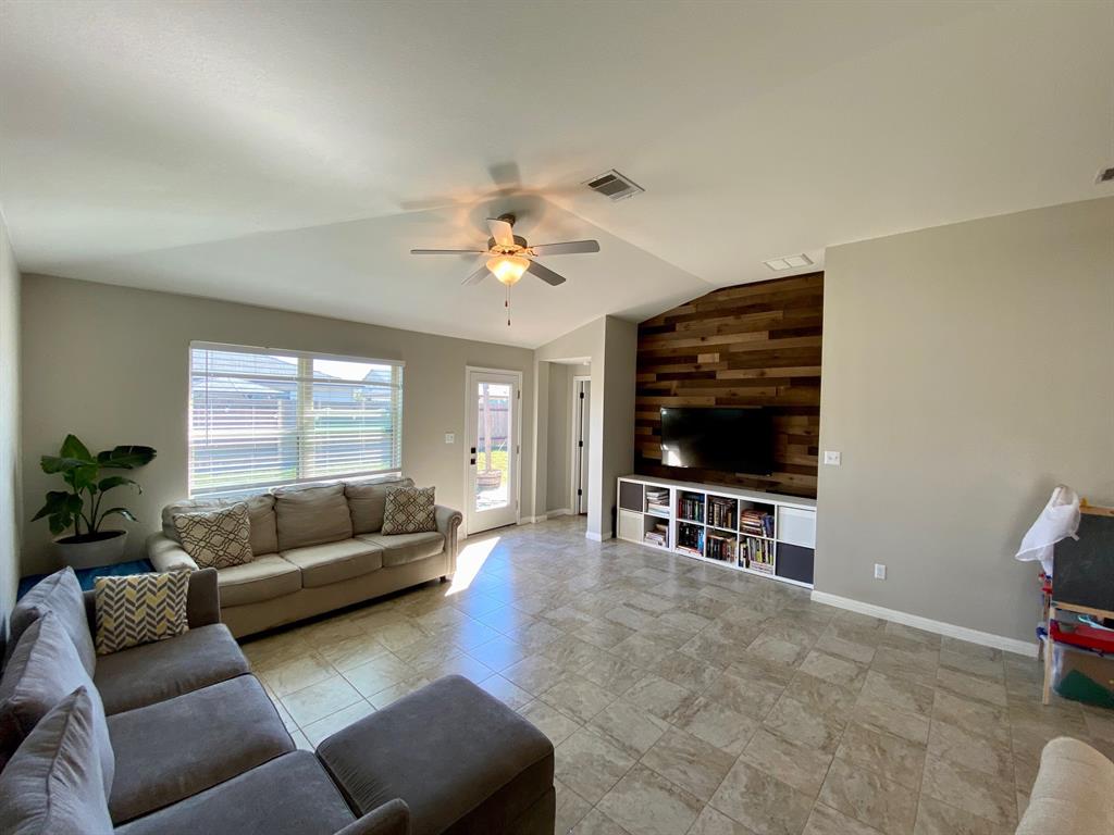 149 Red Sun Drive Kyle, TX 78640 - Photo 7 of 18 a living room with furniture and a flat screen tv