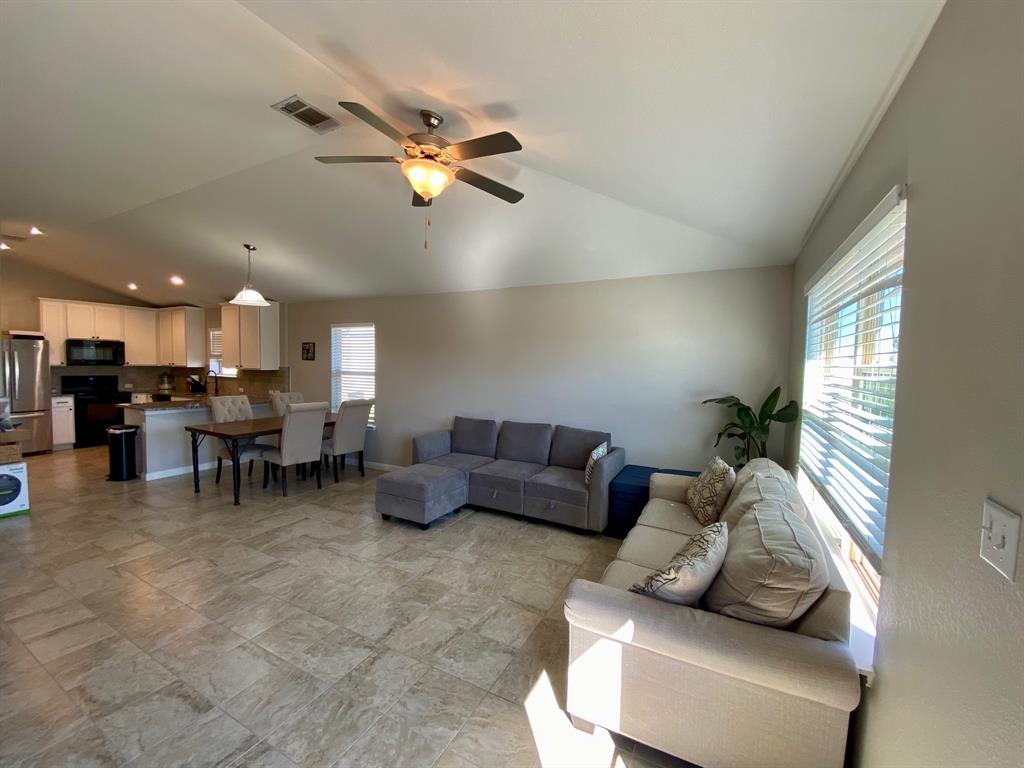 149 Red Sun Drive Kyle, TX 78640 - Photo 8 of 18 a living room with furniture and a chandelier