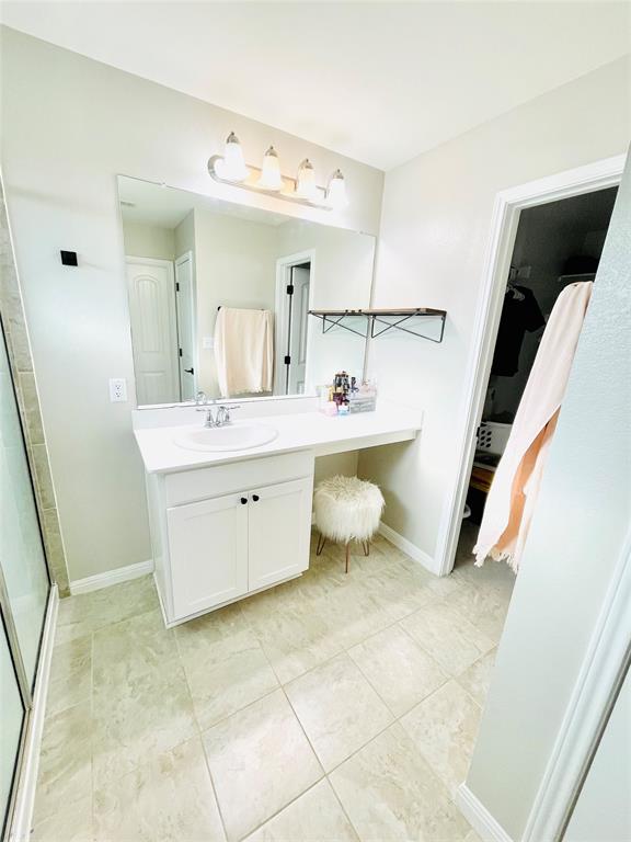 149 Red Sun Drive Kyle, TX 78640 - Photo 10 of 18 a view of a bathroom with a sink a toilet and mirror