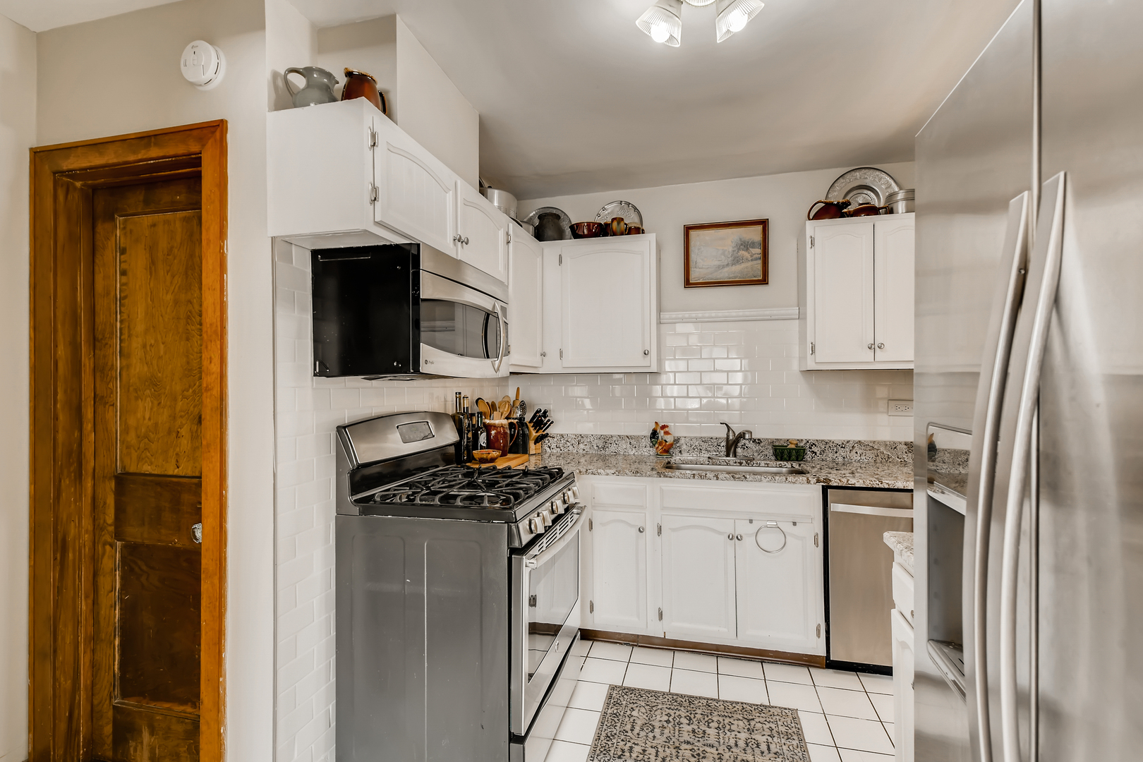 338 Northwood Road Riverside, IL 60546 - Photo 13 of 30 a kitchen with stainless steel appliances a stove refrigerator sink and cabinets