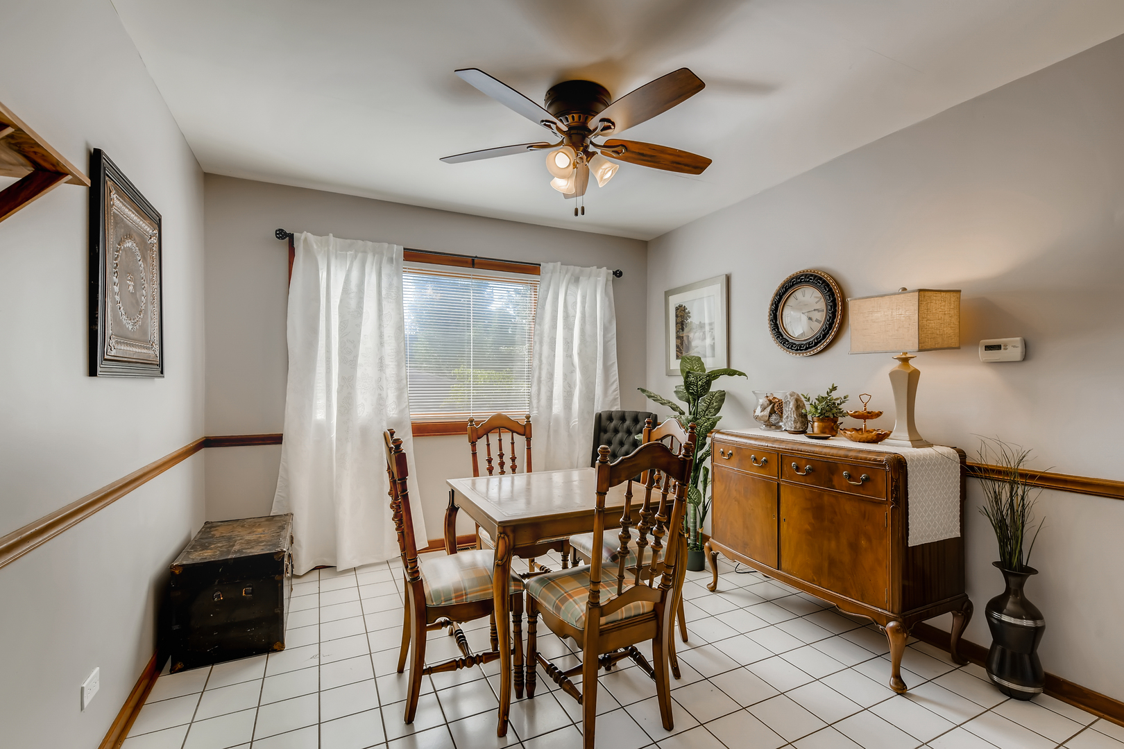 338 Northwood Road Riverside, IL 60546 - Photo 16 of 30 a view of a dining room and livingroom with furniture fan and a large window