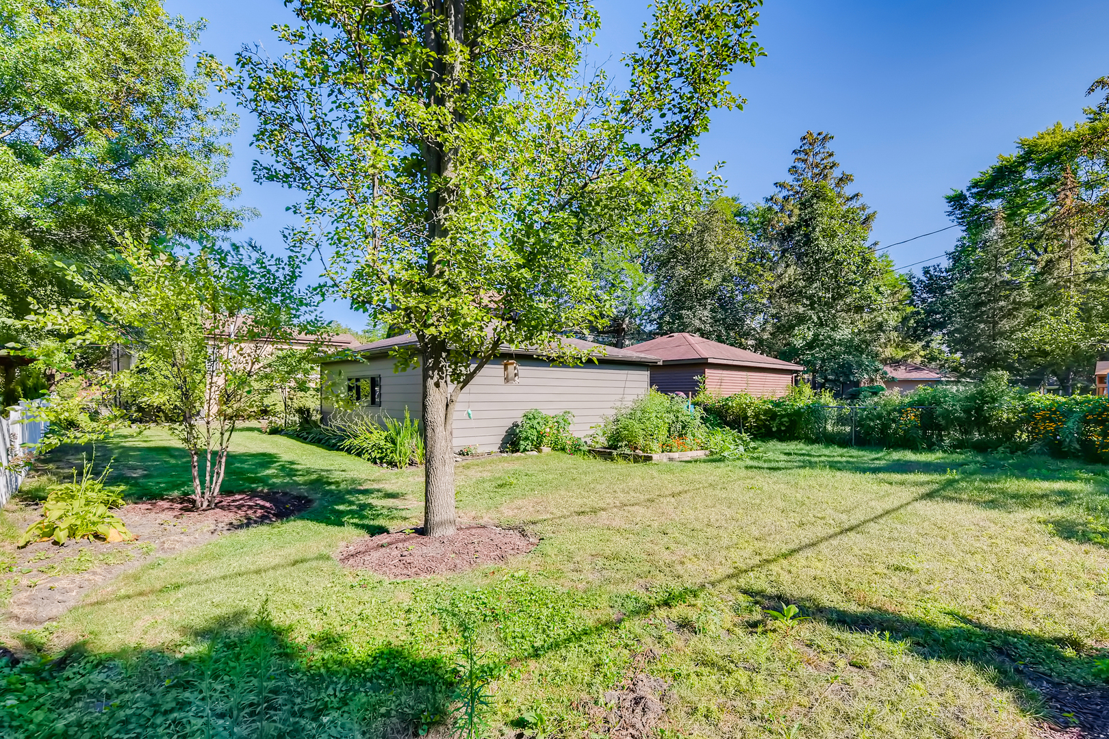 338 Northwood Road Riverside, IL 60546 - Photo 26 of 30 a view of a garden with a building in the background