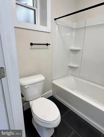 a bathroom with a toilet and a bathtub