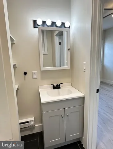 a bathroom with a sink a toilet and mirror