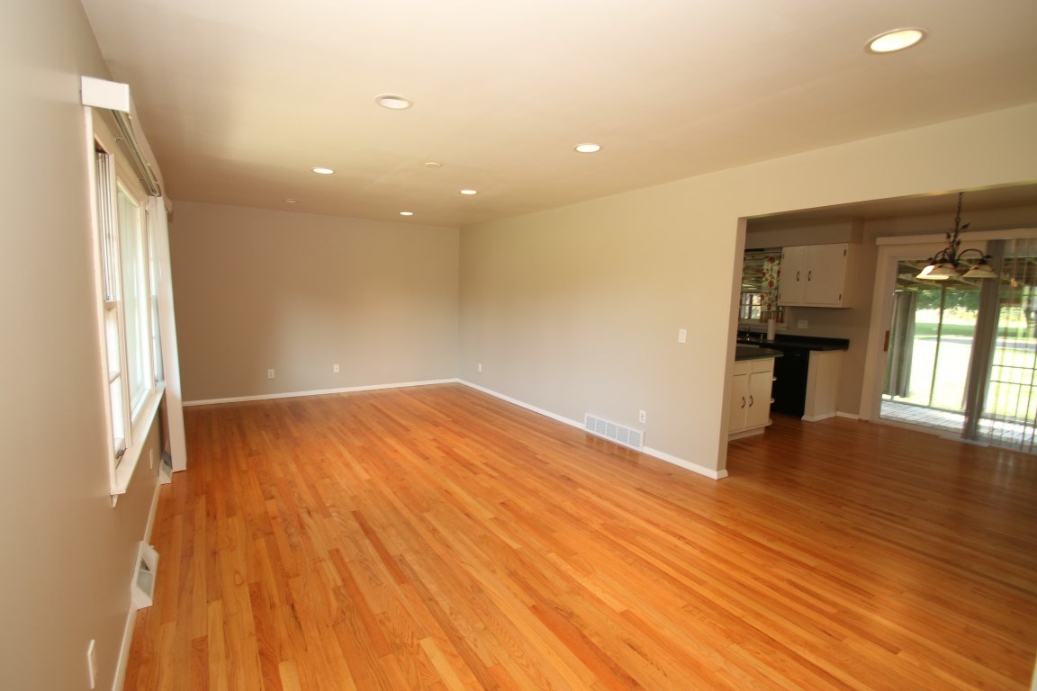 450 North Appleton Road Belvidere, IL 61008 - Photo 3 of 22 wooden floor in an empty room with a window