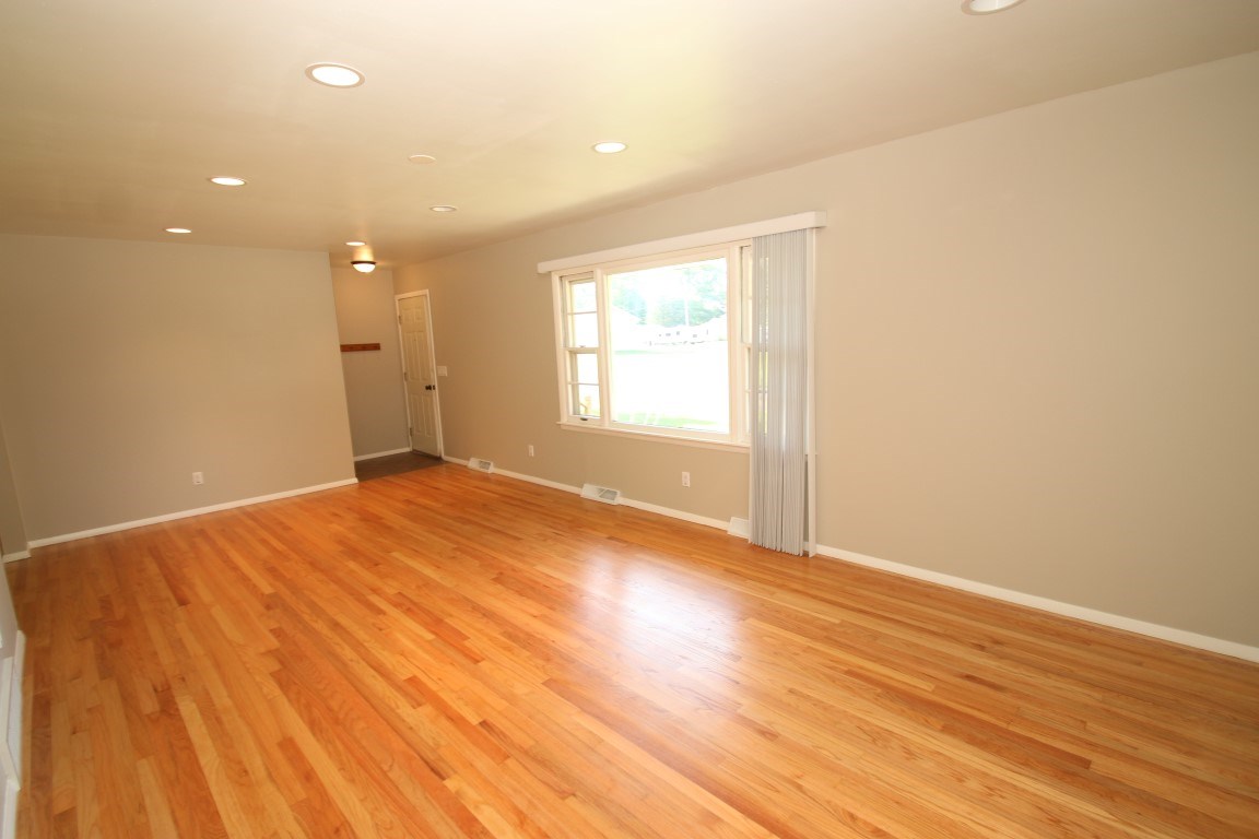 450 North Appleton Road Belvidere, IL 61008 - Photo 4 of 22 an empty room with wooden floor and windows
