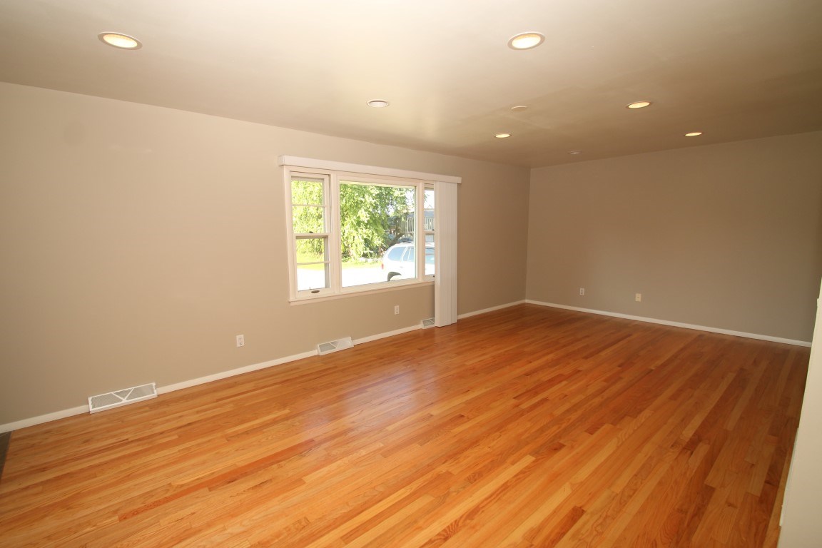 450 North Appleton Road Belvidere, IL 61008 - Photo 5 of 22 an empty room with wooden floor and windows