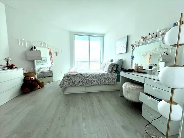 a bedroom with furniture and a wooden floor