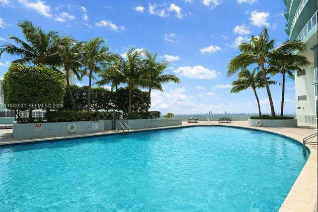 a view of a swimming pool and a yard