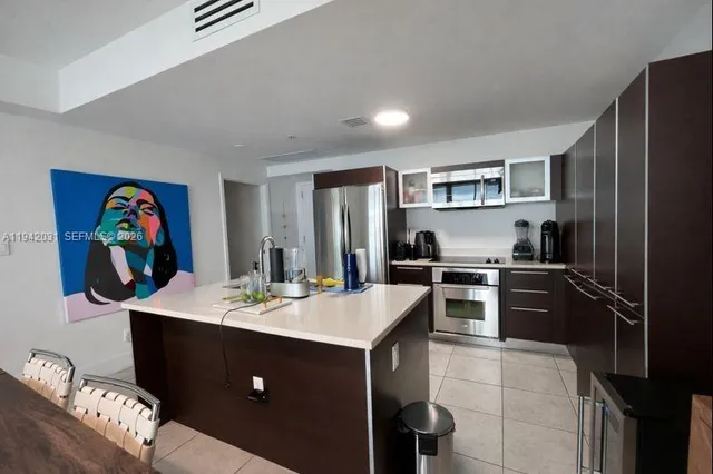 a kitchen with a sink appliances and cabinets