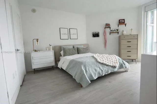 a bedroom with a bed and a dresser