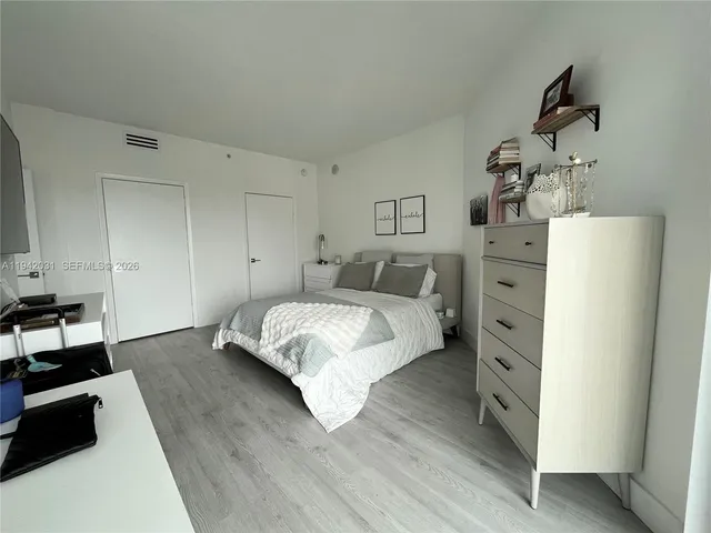 a bedroom with a bed and a dresser