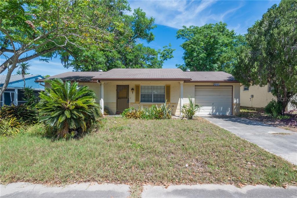 8521 Briar Patch Drive Port Richey, FL 34668 - Photo 1 of 1 front view of house with a yard