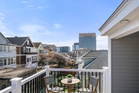 a balcony with table and chairs