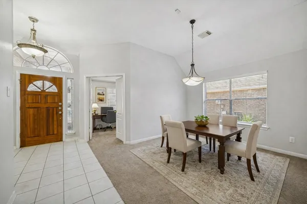 a dining room with furniture and window