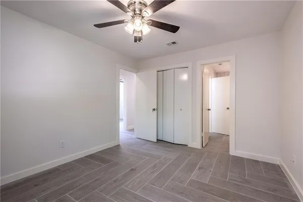 a view of an empty room and wooden floor