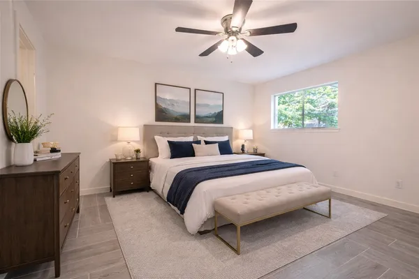 a bedroom with a bed and a chandelier